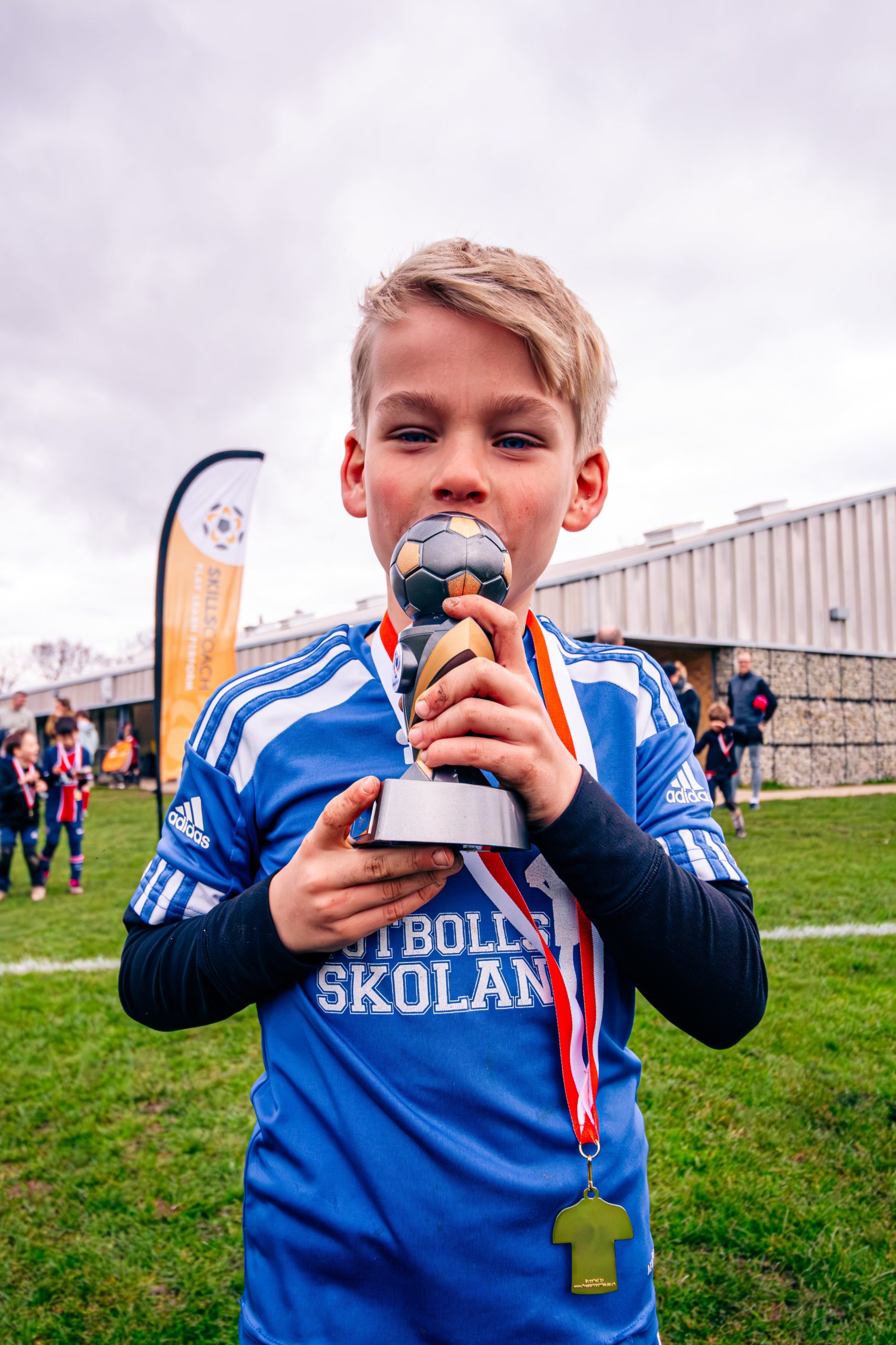 smiling boy with trophy