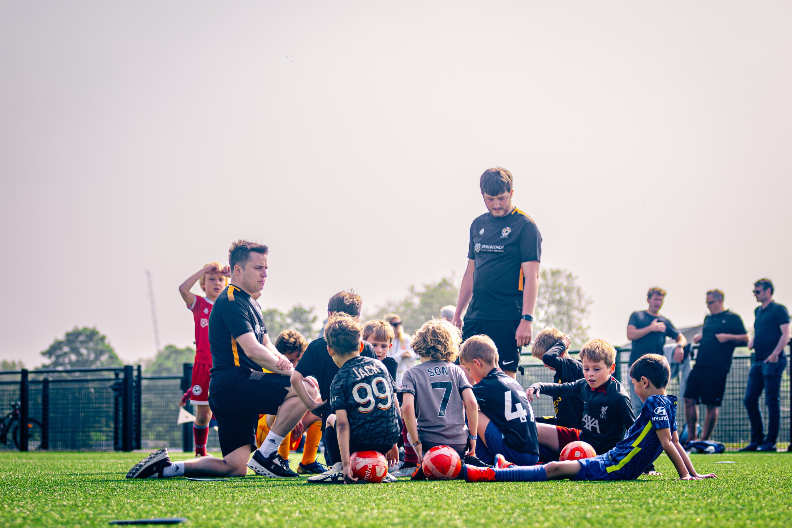 Football Coach talking to children