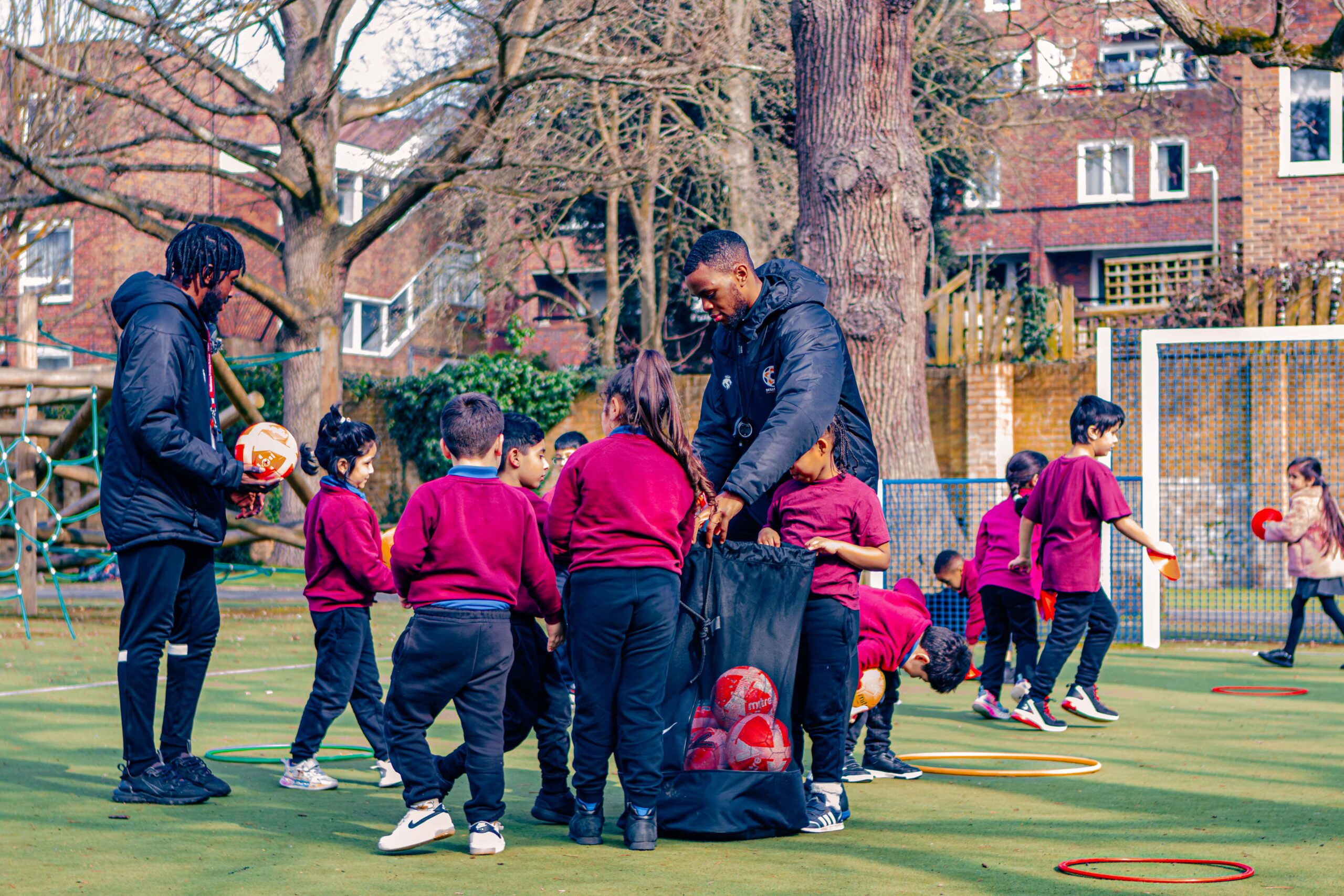 PE Teacher giving out balls to children